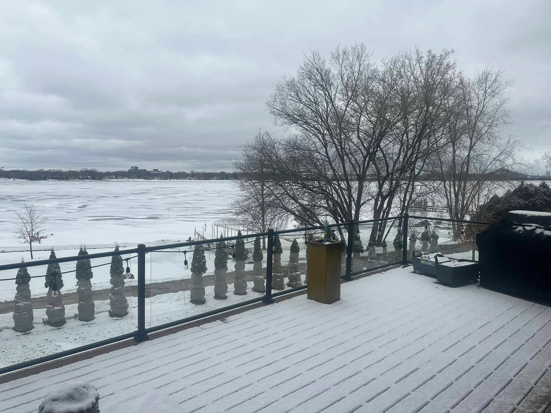 Snow covered deck overlooking a frozen lake near Abrams, WI